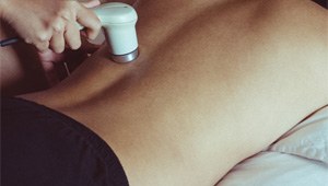 man undergoing cold laser therapy on his back 