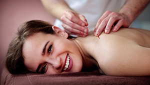 happy, smiling patient getting dry needling