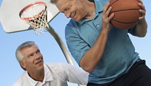 Two men playing basketball