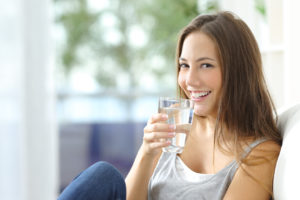 Girl drinking water at home