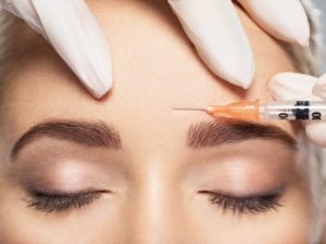 woman getting injected and knowing the difference between BOTOX and dermal fillers