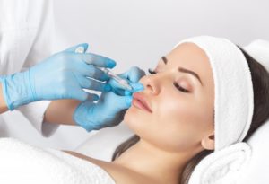 woman getting dermal filler on her face