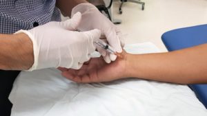 person getting a cortisone injection on their wrist
