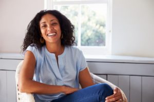 woman sitting on a couch smiling