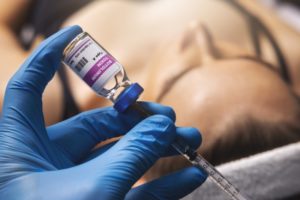 hands filling a syringe with BOTOX