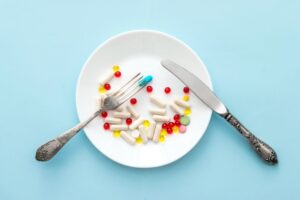 Appetite suppressants on a plate with fork and knife. 